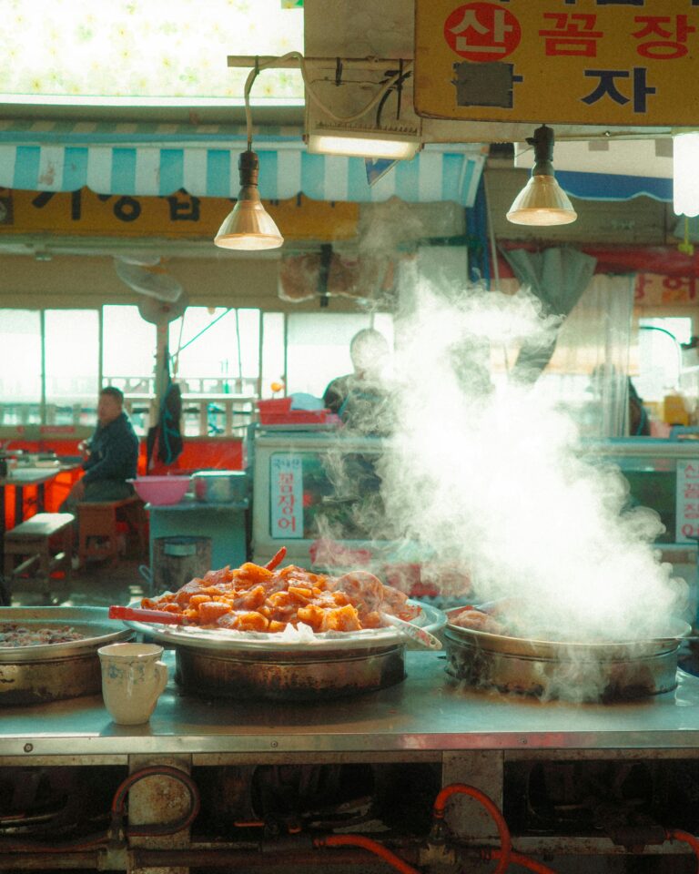 Steaming tteokbokki and Korean street food displayed at a traditional food stall in Korea